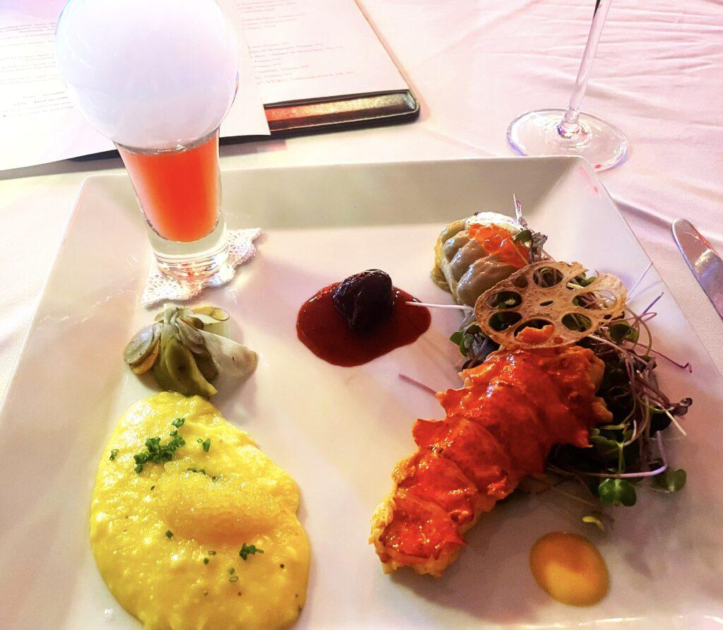 Whitefish Caviar, Foie Gras Crostini & Kona Lobster with Lilikoi, Fermented Rainbow Carrots & Watermelon Smoke Bubble. Image by Emily Simpson,