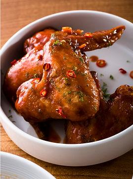Pretty Hot Wings, dotted with fresh bird's eye chilis.  Image by Eric Wolfinger. 