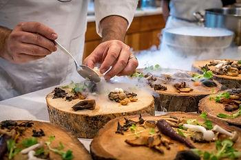 chef plating on tree stump