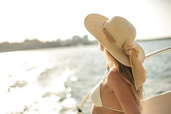 woman with hat on boat
