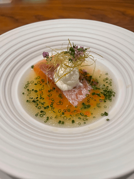 smoked brook trout, served with a grilled leek and trout bone vinaigrette, horseradish, and trout roe