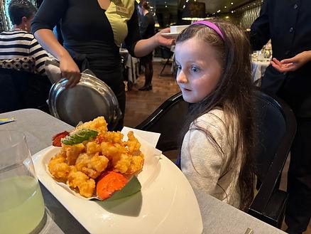 Livia looking at lobster tempura. 