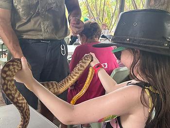 Livia holding a snake at Billabong Sanctuary in Townsville, Australia. A "Life Over Seas" adventure with "The Americans Abroad"