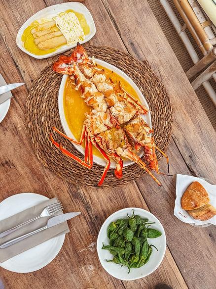A whole grilled spiny lobster platter with a ‘bilbaína’ sauce of olive oil, garlic, and chili. Image by Katherine Rose Woller.