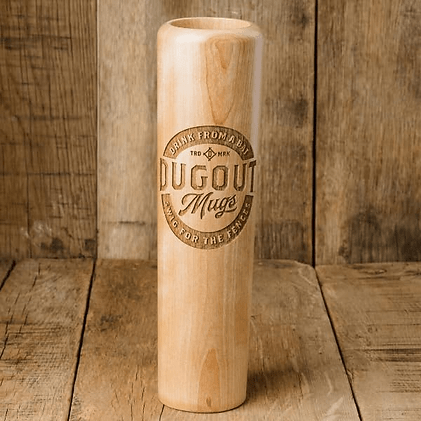 Wooden Dugout Mugs beer cup standing on rustic wood planks, engraved logo centered, warm natural tones.
