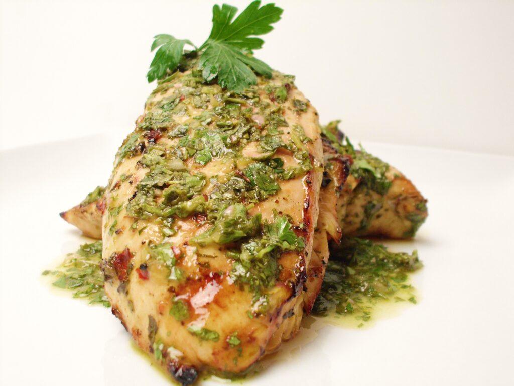 Chimichurri sauce on chicken.  Image by Christianne Klein.