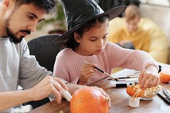 Father and daughter decorating pumpkins. Image by Daisy Anderson.